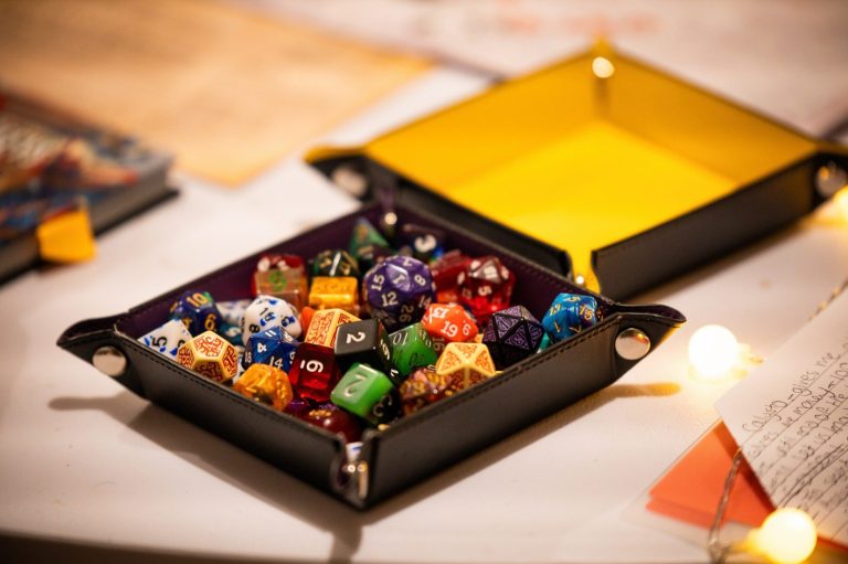 I square table top dice map filled with polyhedral gaming dice.